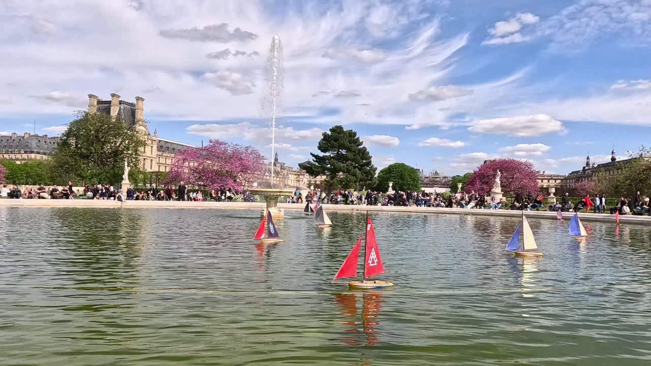 파리 정원 분수에서 떠다니는 장난감 항해 보트