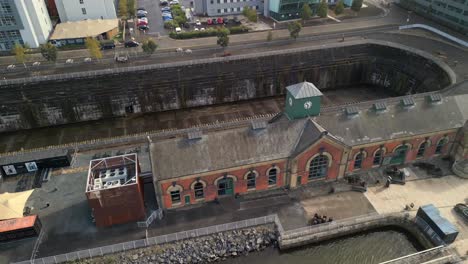 Aerial-shot-of-Titanic-Dry-Docks,-starting-low-and-raising-to-the-sky