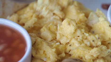 close-up of scrambled eggs with baked beans