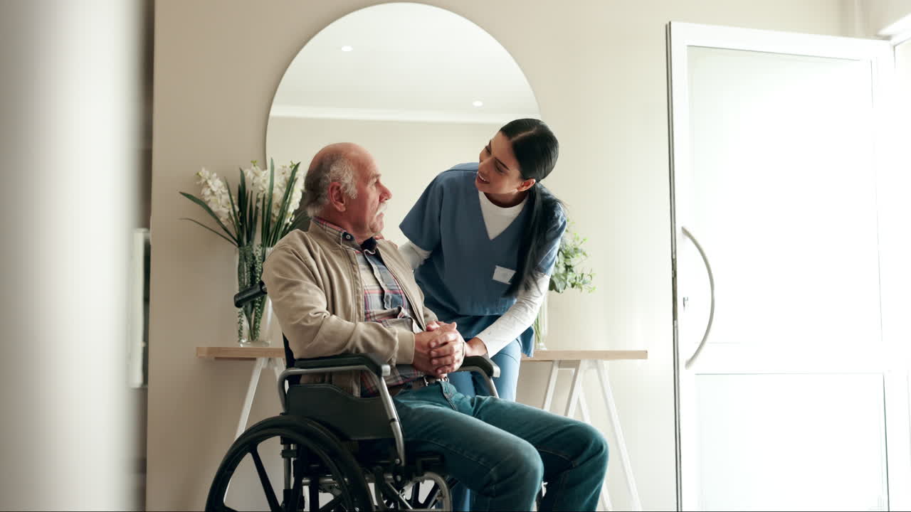 A nurse assisting a senior man in a wheelchair