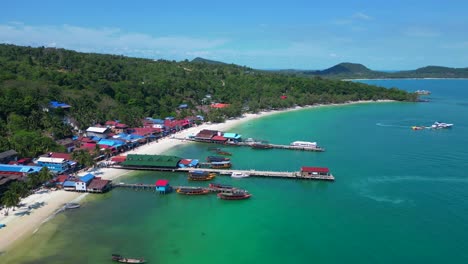 koh rong island in cambodia, featuring turquoise water, pier, boats and tropical jungle. majestic aerial view flight descending drone