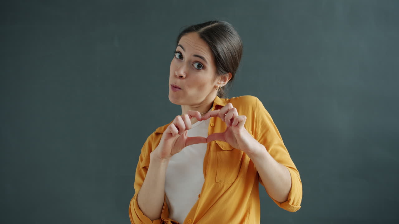 mujer haciendo forma de corazón con las manos