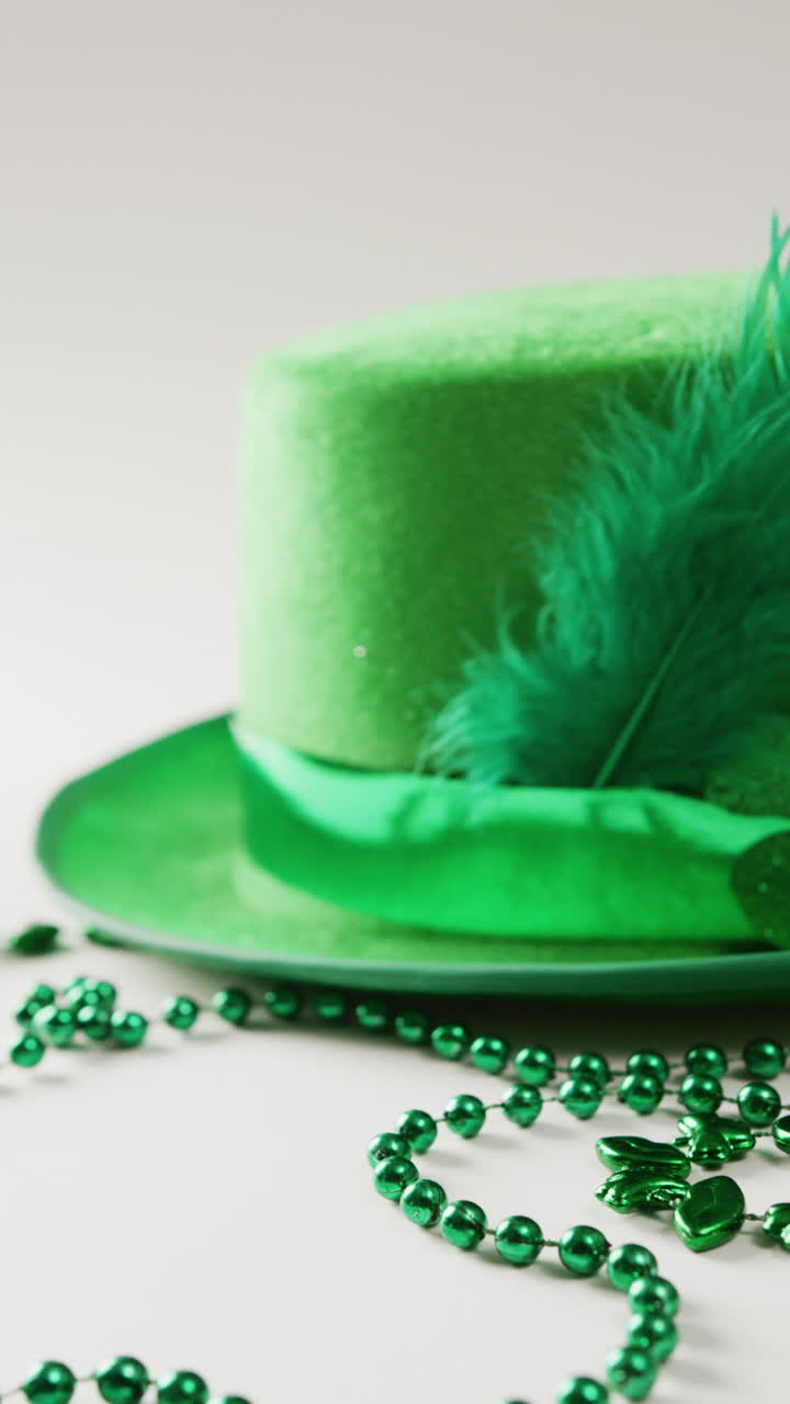 Vertical video of of st patrick's green hat and necklace with copy space on white background