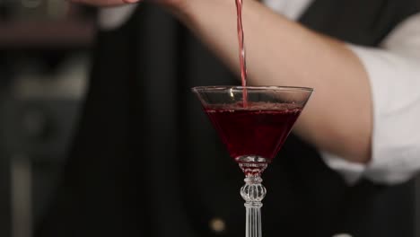 bartender making a red cocktail