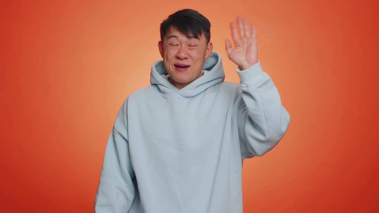 Man showing inviting gesture with hands ask to join beckoning to coming gesturing hello goodbye