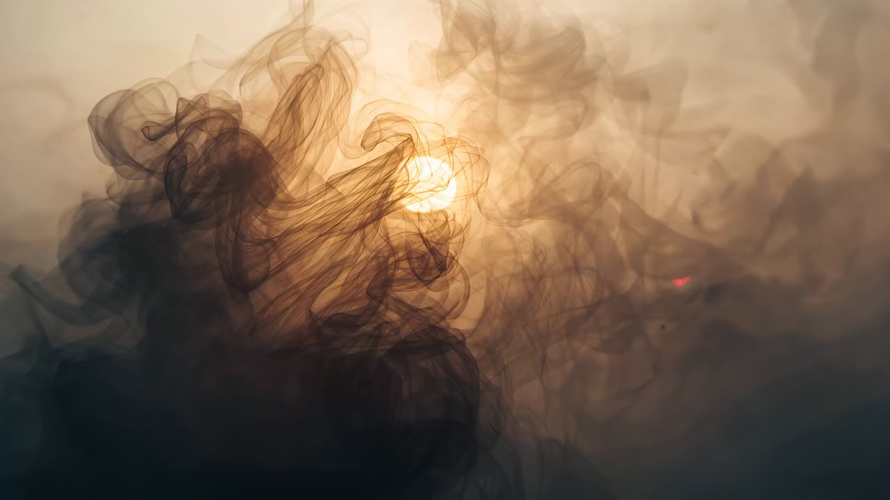 Glowing orb appearing amid smoke wisps, causing plumes swirling then fading in studio amber haze
