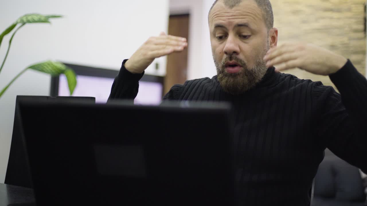 A worried man on the phone in the living room