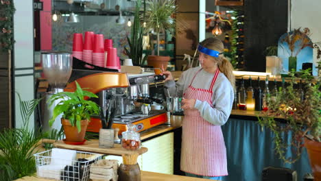 barista making coffee in a cafe