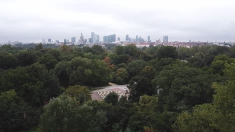 Nice-drone-shot-of-warsaw-city-skyline-from-far-away-with-forest-below-it