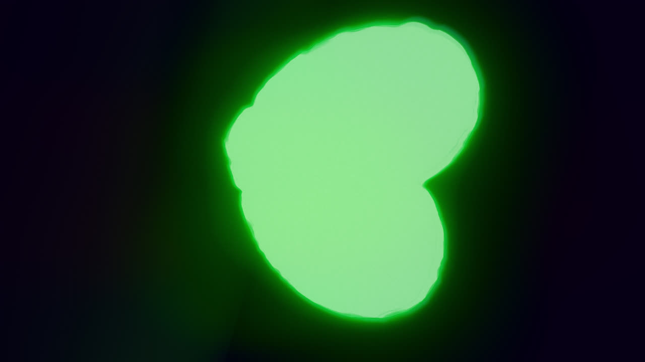 Green energy heart shapes on a dark background