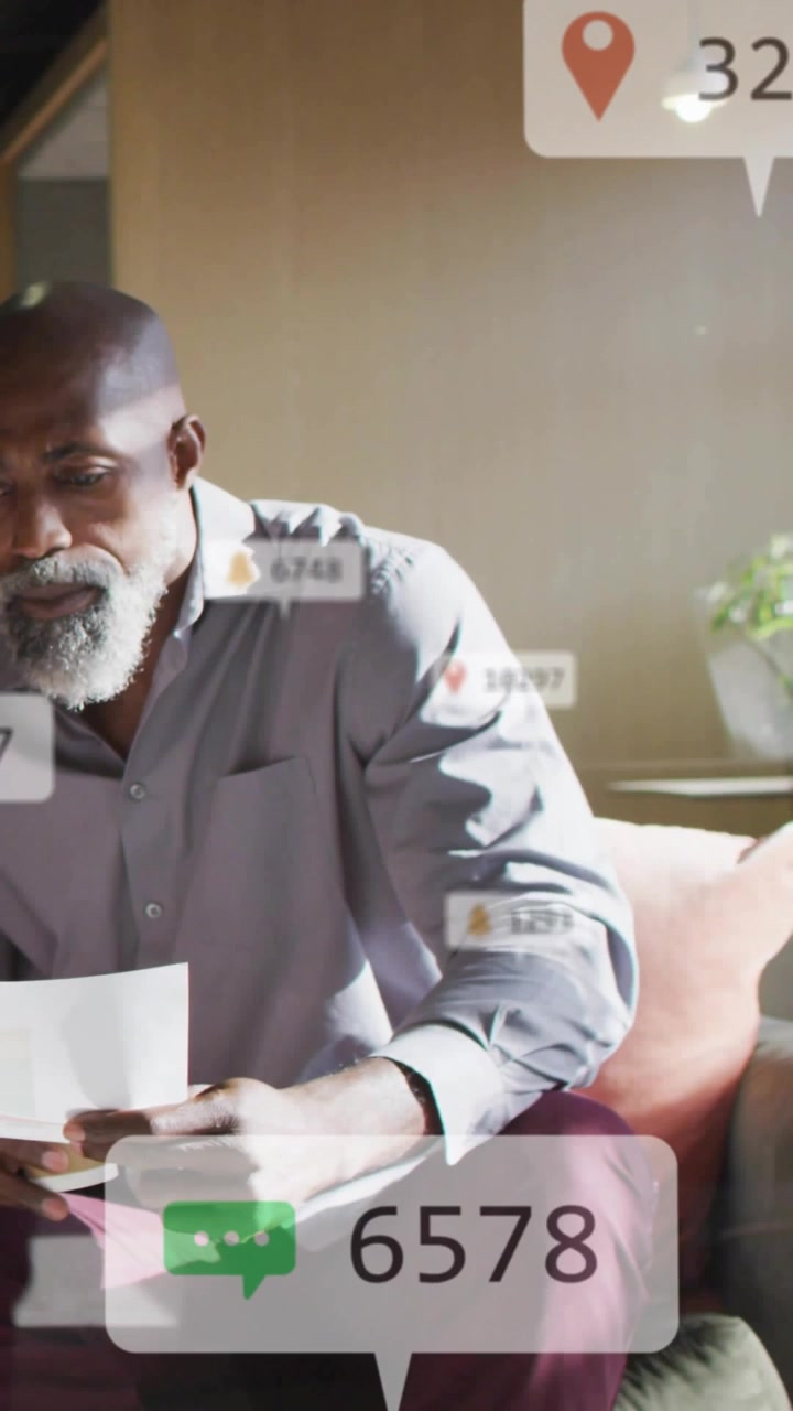 Vertical video: Reacting to alerts man in gray shirt reading sheet home lifting cup checking counts