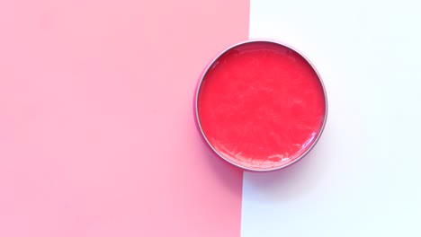 pink lip balm in metal tin