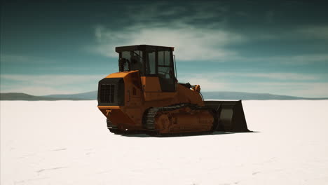road grading machine on the salt desert road