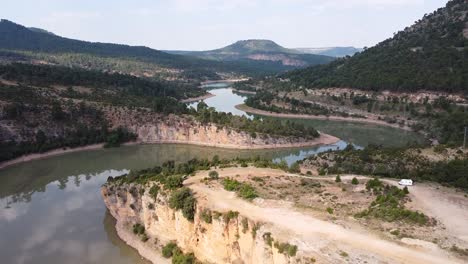 Embalse-de-La-Toba-Lake-at-Serrania-de-Cuenca,-Spain---Aerial-Drone-View-of-the-Tortuous-Water-Reservoir-and-Motorhome