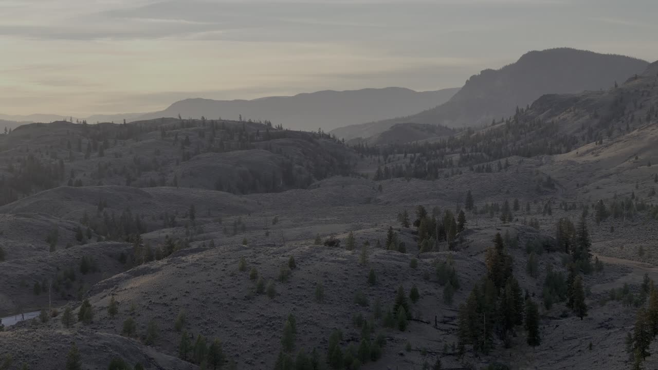 Aerial Panorama of Lac Du Bois' Grasslands and Forested Mountains