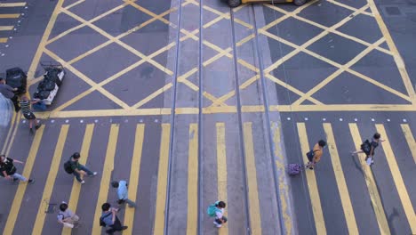 pedestrians walk across the road through a zebra crossing in central district, hong kong