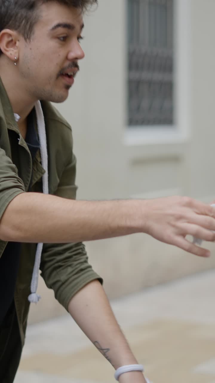 A man with a mustache and short hair interacting with a rope outdoors