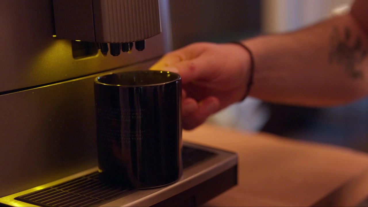 Close-up view, automatic coffee machine pouring a hot drink into a mug in a cozy indoor setting. Concept of coffee, refreshment, morning routine and home comfort