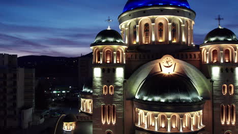 medium, aerial shot of the illuminated orthodox cathedral in the centrum of deva, romania