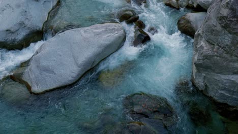 Powerful-torrential-flow-is-running-over-the-giant-rocks-in-Cavergno-village,-Switzerland