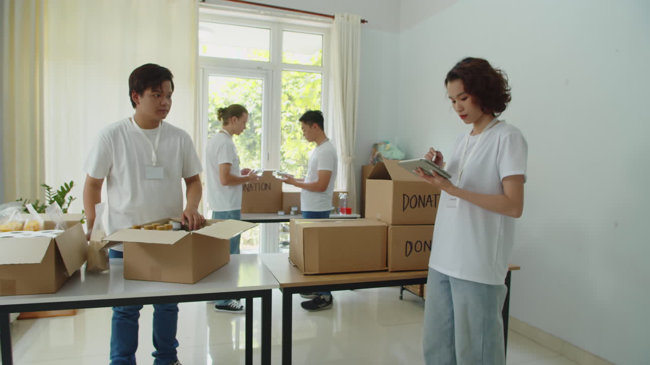Female Volunteer Keeping Count of Donation Boxes in Fund