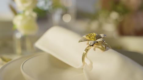 close up of napkin in ring on table set for meal at wedding reception in restaurant 2