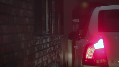 drive-thru cashier accepts money from customer for their order at a fast food restaurant in the city during the night time