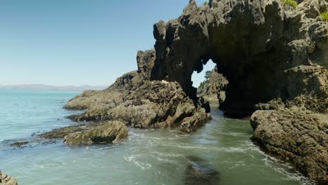 mesmerizing cliffside hole, where water rhythmically rises and falls, a captivating dance of nature's ebb and flow