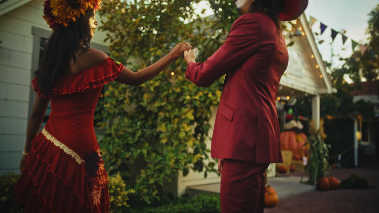 Couple in Halloween Costumes Walking Through Decorated Town
