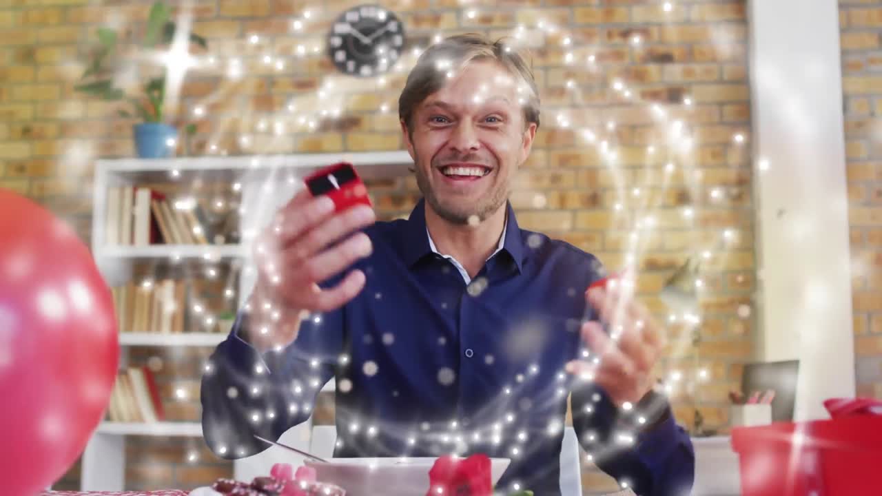 animación del anillo con luces brillantes sobre el hombre caucásico sosteniendo el anillo de compromiso.