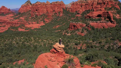 Aerial-of-two-lovers-couple-standing-on-red-peak-butte-near-Sedona-Arizona