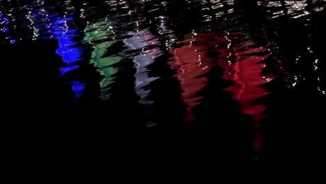 4k-Water-Colours-Reflection-in-Slow-Motion-at-CANADA-PLACE,-Sails-of-Light-at-Night-Reflecting-on-water,-Downtown-Vancouver-British-Columbia,-seen-from-Stanley-Park-sea-wall