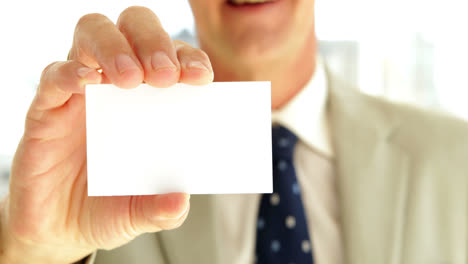 businessman showing his card to camera