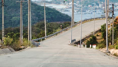 zoom out of empty road with asphaly island floating fishing farms in background