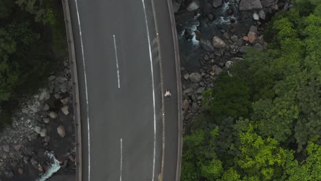 Walking-across-bridge-over-forest-in-Yakushima-Japan,-Top-Down-Aerial-View