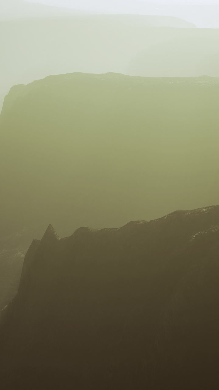 Foggy cliffside view at dawn reveals dramatic landscapes in soft light