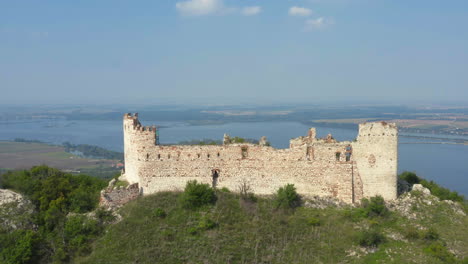 ruins of děvičky castle in moravia, mikulov in distance, drone shot