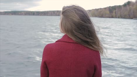 woman contemplating lakeside view