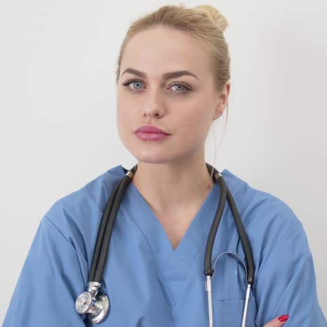 beautiful young female doctor wearing blie medical coat with stethoscope isolated on white