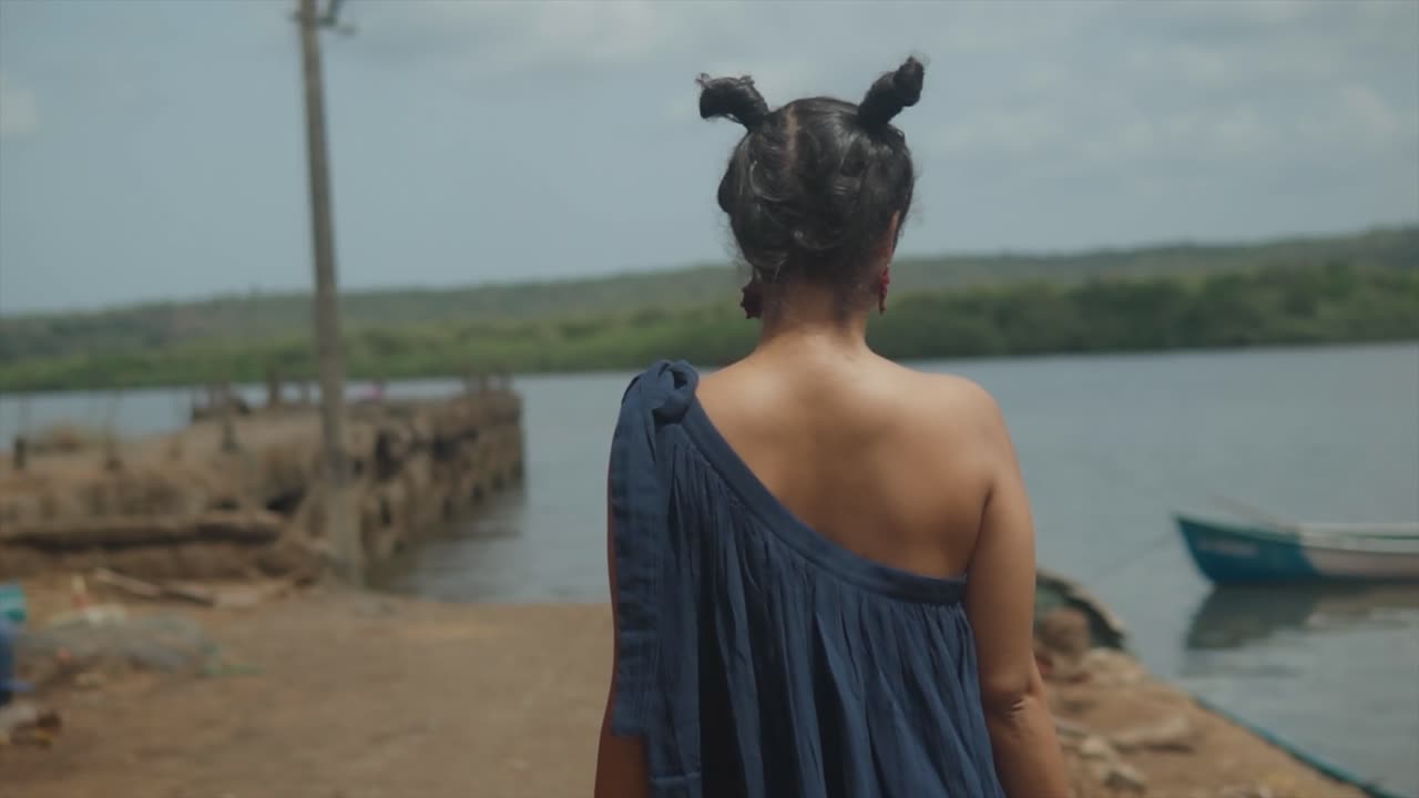 en una sorprendente declaración de moda, he aquí una modelo asiática india caminando con confianza en solitario en el puerto, adornada con un extraordinario conjunto y un peinado único en su tipo