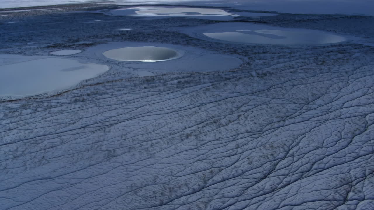 Aerial View of Arctic Landscape with Frozen Lakes and Intricate Ground Patterns