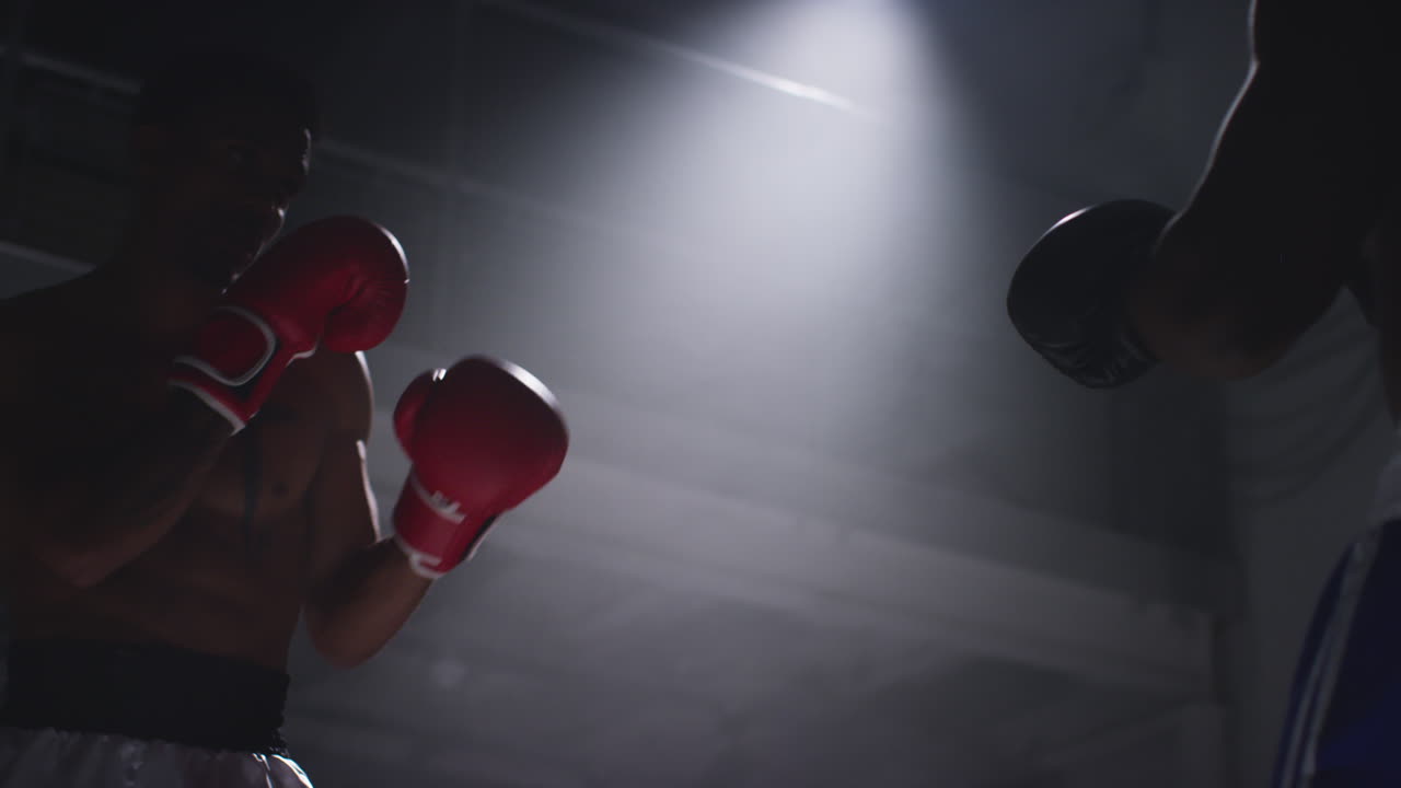Close Up Shot Of Two Male Boxers Wearing Gloves In Boxing Ring Fighting In Boxing Match With Low Key Lighting 4