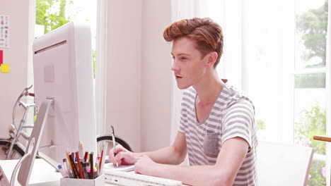 a men writing in a paper