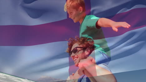 animation of flag of england over caucasian man carrying son piggyback on beach