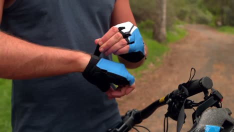 man wearing his gloves for biking