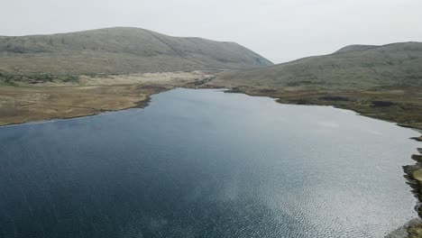 tilt down aerial view of spelga reservoir and mourne mountains