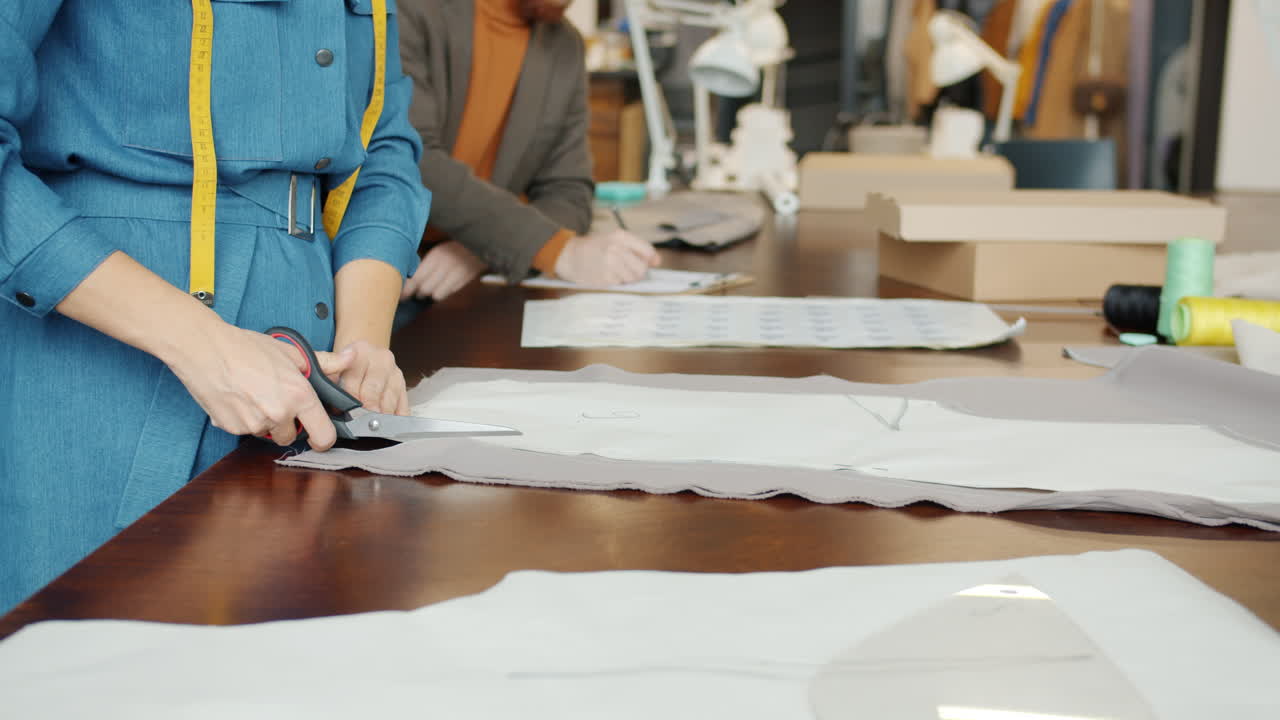 Fashion Designers Working on Clothes in a Studio