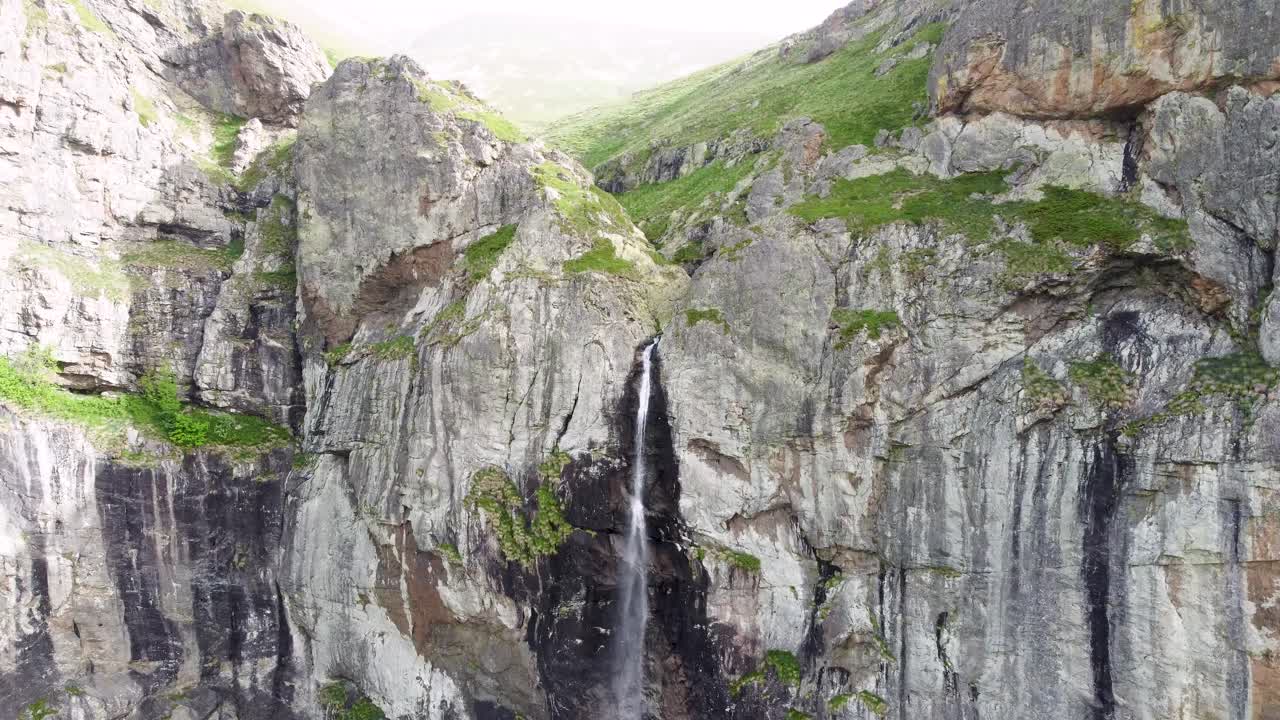 Majestic Waterfall cascading down a steep cliff face in a mountainous region