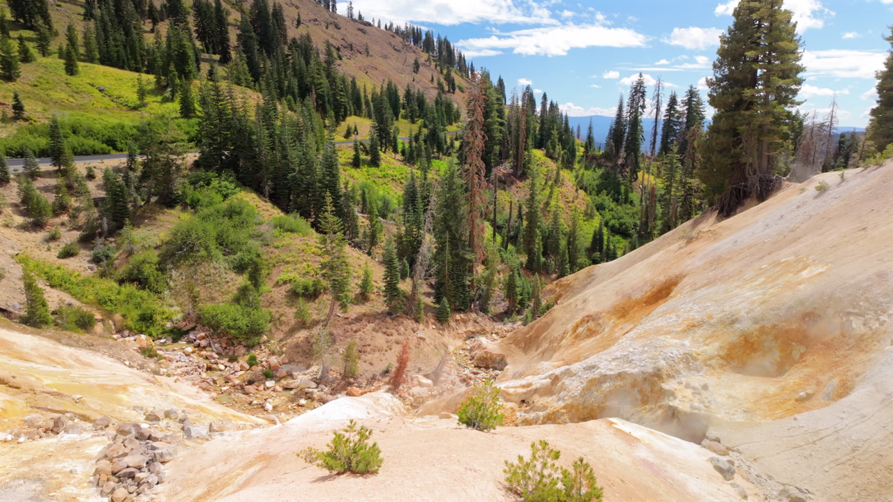 Sulfur springs emitting steam on bright day at Lassen Volcanic National Park, California, United States