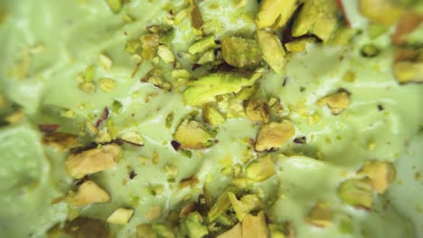delicious creamy pistachio ice cream captured in a top-down macro shot, surrounded by raw pistachio nuts